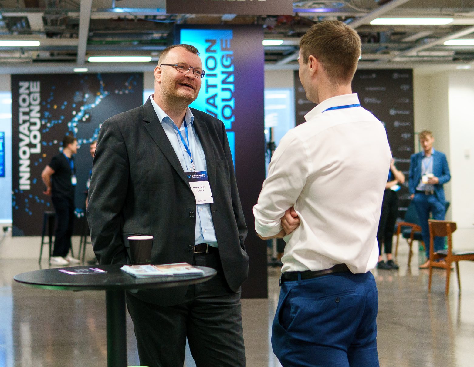 Group of attendees networking and smiling at the London 2023 event.